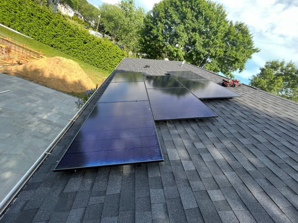 Aerial view of a Hamptons coastal estate with solar installation