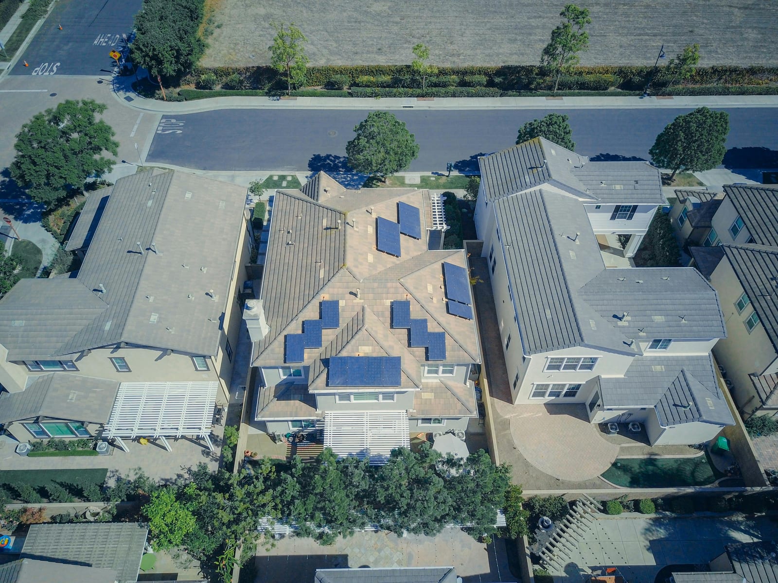 Aerial view of closely set homes with rooftop solar panels